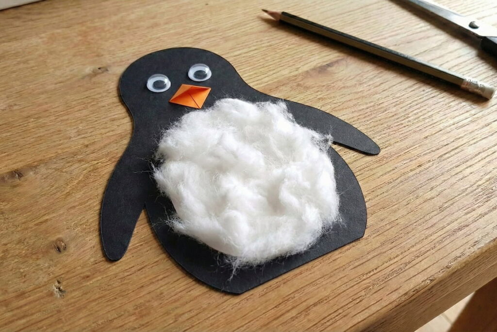 Tučňák s nalepenýma očima, zobákem a huňatým bříškem.